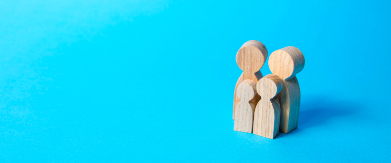 two adult blocks and two child blocks in a group with a blu background
