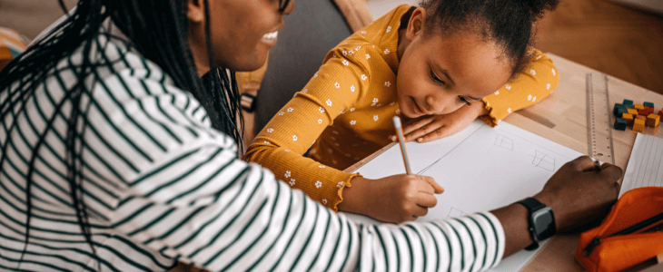 Mother working with her daughter on homeschooling curriculum