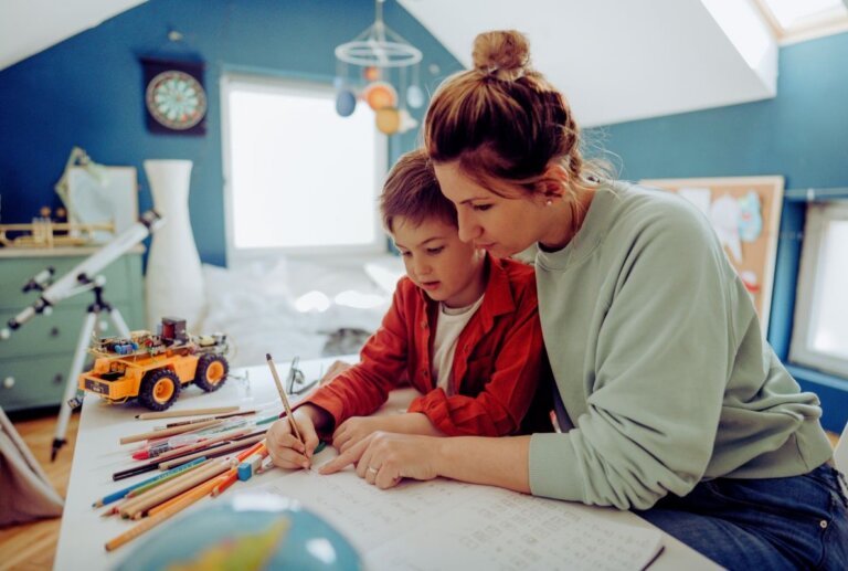 Mother helping her child with schoolwork at home