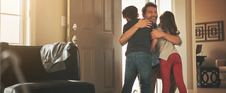 Shot of a father arriving home to a loving welcome from his son and daughter