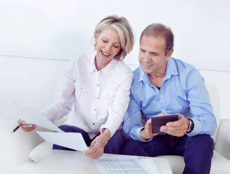 Mature couple reviewing documents together at home