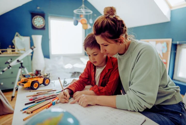 Mother helping her child with schoolwork at home